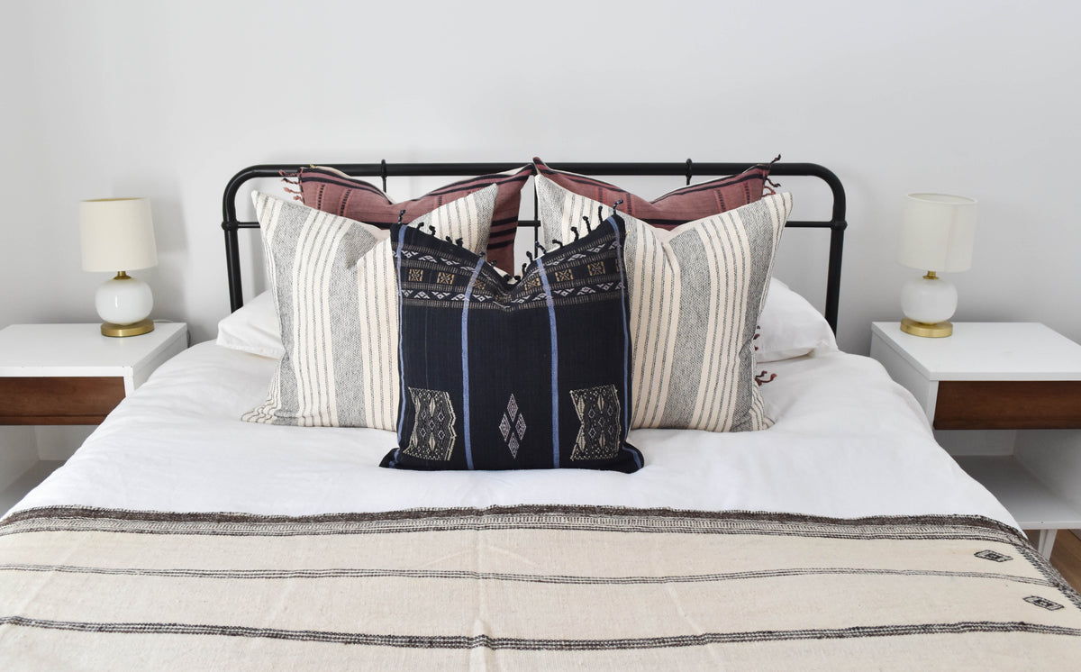 Handmade pillows styled on bed