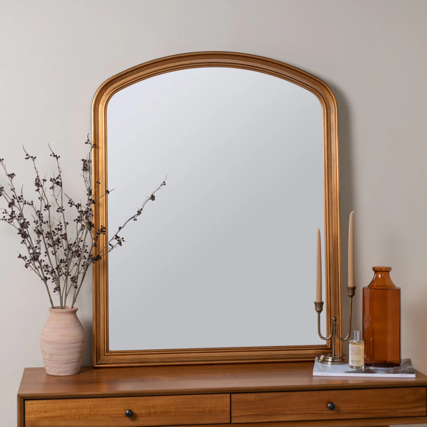 arched antique gold finish wall mirror with traditional design detailing.