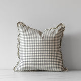 White square pillow with black fine grid pattern with small ruffle trim border.