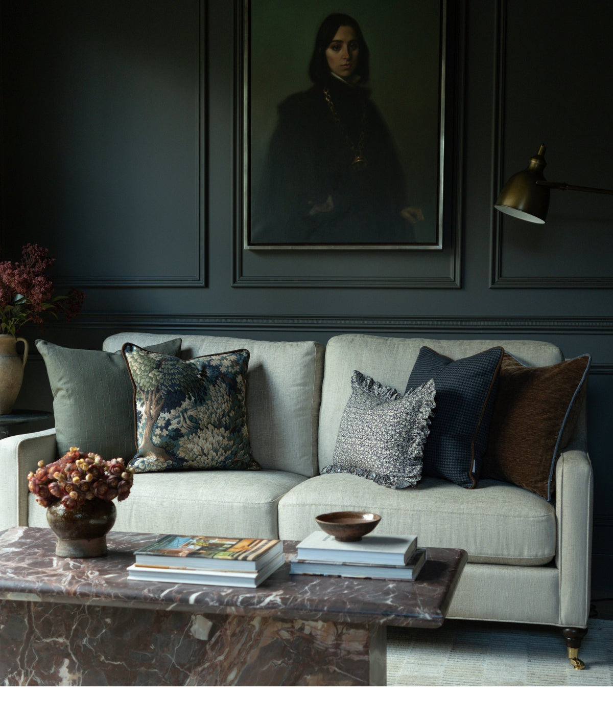 Living room with a sage sofa, patterned Rug & Weave pillows and a marble coffee table