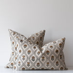 Floral block print pillow covers with green vines and beige linen background